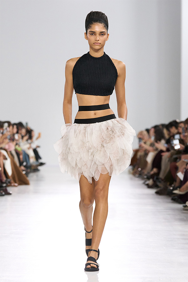 Max Mara Spring/Summer 2026 Fashion Show - Look with Black Sleeveless Top and White Skirt.