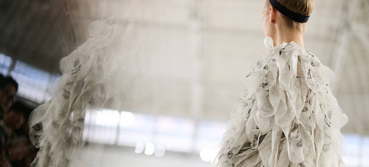 Sfilata Max Mara Primavera Estate 2026 - Modella di spalle con abito bianco.